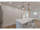 This kitchen has a kitchen island with quartz countertop and modern lighting at 525 Rosemont Dr, Decatur, GA 30032