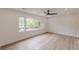 Living room features large windows overlooking greenery and wood flooring at 525 Rosemont Dr, Decatur, GA 30032