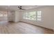 Bright living room featuring new wood flooring and large double windows at 525 Rosemont Dr, Decatur, GA 30032
