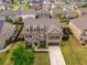 Overhead view of a landscaped brick home with a driveway and manicured lawn in a suburban neighborhood at 590 Birkdale Dr, Fairburn, GA 30213
