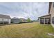 Spacious backyard featuring a well-maintained lawn and enclosed sunroom attached to the home at 590 Birkdale Dr, Fairburn, GA 30213