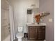 Cozy bathroom with shower-tub combo, dark vanity and neutral wall color at 590 Birkdale Dr, Fairburn, GA 30213