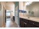 Stylish bathroom featuring tiled floors, a large mirror and dark wood vanity and cabinets at 590 Birkdale Dr, Fairburn, GA 30213