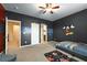 Inviting bedroom featuring playful wall decor, carpeted floors, and easy access to en-suite bathroom at 590 Birkdale Dr, Fairburn, GA 30213