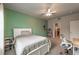 Cozy bedroom offering neutral carpet, a ceiling fan, and en-suite bathroom access at 590 Birkdale Dr, Fairburn, GA 30213