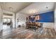 Formal dining room featuring a dark blue accent wall and wood-look flooring at 590 Birkdale Dr, Fairburn, GA 30213