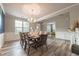 Bright dining room with large window and chandelier, perfect for Gathering meals and entertaining guests at 590 Birkdale Dr, Fairburn, GA 30213