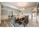 Formal dining room features hardwood floors, wainscoting, and a modern chandelier for elegant gatherings at 590 Birkdale Dr, Fairburn, GA 30213