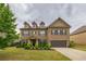 Traditional two-story brick home with well-manicured lawn and attached two-car garage at 590 Birkdale Dr, Fairburn, GA 30213