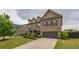 Two-story brick house featuring a well-manicured front lawn and a spacious driveway at 590 Birkdale Dr, Fairburn, GA 30213