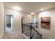 Second floor hallway featuring carpeting, doors to multiple rooms, and a dark-wood railing staircase at 590 Birkdale Dr, Fairburn, GA 30213
