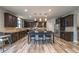 Spacious kitchen featuring a large island with seating, stainless steel appliances, and dark wood cabinets at 590 Birkdale Dr, Fairburn, GA 30213