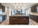 Open concept kitchen with a large island and seating that extends into the living room at 590 Birkdale Dr, Fairburn, GA 30213