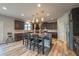 Bright, spacious kitchen featuring a large island with seating, stainless steel appliances, and dark wood cabinets at 590 Birkdale Dr, Fairburn, GA 30213