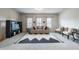 Bright living room with decorative area rug, neutral walls, and lots of seating at 590 Birkdale Dr, Fairburn, GA 30213