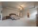 Bright, spacious main bedroom boasts a tray ceiling and neutral decor at 590 Birkdale Dr, Fairburn, GA 30213