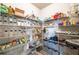 Organized walk-in pantry with abundant shelving and various food storage containers at 590 Birkdale Dr, Fairburn, GA 30213