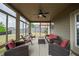 Inviting sunroom with cozy wicker furniture, ceiling fan, and views of the backyard at 590 Birkdale Dr, Fairburn, GA 30213