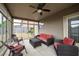 Relaxing sunroom with wicker furniture and a ceiling fan overlooking the yard at 590 Birkdale Dr, Fairburn, GA 30213