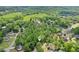 Aerial view of homes surrounded by lush trees, highlighting the natural beauty of the neighborhood at 6230 Lillie Lane, Cumming, GA 30040