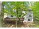 Back of home featuring an elevated deck overlooking the yard, offering a private outdoor space at 6230 Lillie Lane, Cumming, GA 30040