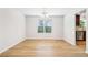 Dining room with natural light, wood floors, and a view into kitchen, ideal for Gathering meals at 6230 Lillie Lane, Cumming, GA 30040