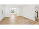 Inviting living room with hardwood floors, windows, and staircase access at 6230 Lillie Lane, Cumming, GA 30040