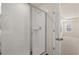 Modern bathroom features a glass shower and open doorway to bedroom at 1109 Blue Juniper Cir, Loganville, GA 30052