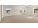 Expansive bedroom with multiple windows for ample natural lighting and plush carpeting at 1109 Blue Juniper Cir, Loganville, GA 30052