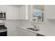 Close up of the kitchen's sink, appliances, and tile backsplash at 1109 Blue Juniper Cir, Loganville, GA 30052