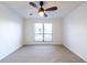 A carpeted bedroom with large window offers natural light, while a ceiling fan provides efficient climate control at 2657 Lenox Ne Rd # 68 Bld, Atlanta, GA 30324