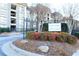 Exterior view of Lenox Green Condominium entrance sign with colorful landscaping and a black wrought iron fence at 2657 Lenox Ne Rd # 68 Bld, Atlanta, GA 30324