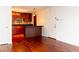 An open kitchen with dark wood cabinets and granite countertops adjoins a dining area with wood floors at 2657 Lenox Ne Rd # 68 Bld, Atlanta, GA 30324