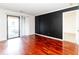 Bright living room featuring gleaming hardwood floors, access to a balcony, and a custom feature wall at 2657 Lenox Ne Rd # 68 Bld, Atlanta, GA 30324