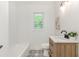 Charming bathroom with a tub, shower, patterned tile, and modern vanity at 3181 Pennington Sw Cir, Atlanta, GA 30354