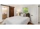 Cozy bedroom with natural light, a barn door to the bathroom, and hardwood floors at 3181 Pennington Sw Cir, Atlanta, GA 30354