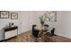 Dining area featuring hardwood floors and a modern glass table with black chairs at 3181 Pennington Sw Cir, Atlanta, GA 30354