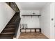 Inviting foyer featuring stairs, a bench with pillows, and convenient shelving at 3181 Pennington Sw Cir, Atlanta, GA 30354