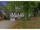Charming two-story home with a driveway and lush green trees around the property at 3181 Pennington Sw Cir, Atlanta, GA 30354