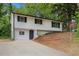 Two-story home featuring a freshly painted white exterior and long driveway at 3181 Pennington Sw Cir, Atlanta, GA 30354