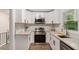 Modern kitchen with stainless steel appliances, white cabinets, and granite countertops at 3181 Pennington Sw Cir, Atlanta, GA 30354