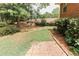 Landscaped backyard with a brick path and lush greenery at 3572 Stone Ridge Trl, Douglasville, GA 30134