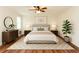 Stylishly decorated bedroom with hardwood floors, a ceiling fan, and a serene ambiance at 3572 Stone Ridge Trl, Douglasville, GA 30134