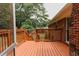 Spacious deck with wood railing that overlooks the landscaped backyard at 3572 Stone Ridge Trl, Douglasville, GA 30134