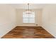 Cozy dining room with wainscotting and a contemporary chandelier at 3572 Stone Ridge Trl, Douglasville, GA 30134