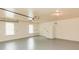 Large garage with a sealed floor, a refrigerator, built-in shelves, and bright lighting at 3572 Stone Ridge Trl, Douglasville, GA 30134