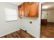 Functional laundry room with wood floors, storage cabinets and natural light at 3572 Stone Ridge Trl, Douglasville, GA 30134