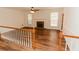 Open-concept living area with a fireplace, hardwood floors, and natural light at 3572 Stone Ridge Trl, Douglasville, GA 30134