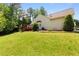 Spacious backyard featuring lush green grass and mature landscaping with a deck at 6416 Chestnut Glen Dr, Norcross, GA 30071