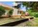 Spacious backyard featuring a well-maintained lawn, trees, and a charming greenhouse attached to a red deck at 6416 Chestnut Glen Dr, Norcross, GA 30071